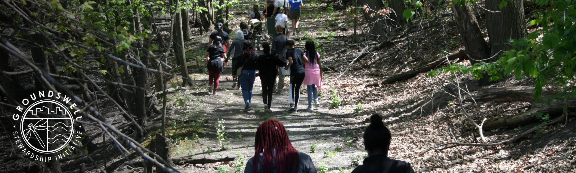 Groundswell over picture of students walking through nature